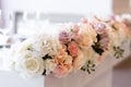 Lovely floral design on the groom and bride `s desk. Roses and cloves