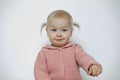 Lovely funny baby girl isolated on white. Portrait of smiling toddler in studio. Blonde haired child with joyful facial Royalty Free Stock Photo