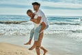 Lovely gay couple on piggyback ride at the beach Royalty Free Stock Photo