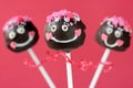 Lovely girl cake pops on pink background