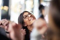 Lovely girl cheering success with coleagues and friends at a cafe. Looking up