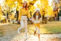 Lovely girl with her mom having fun on the walk. Autumn holidays, lifestyle
