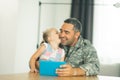 Lovely girl kissing daddy wearing military uniform Royalty Free Stock Photo