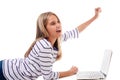 Lovely girl laying on the floor using laptop and celebrating victory,isolated Royalty Free Stock Photo