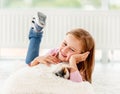 Girl holding guinea pig on the floor Royalty Free Stock Photo