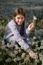 Lovely Girl Making Bunch of Dandelion Flowers on Beautiful Dandelion Field Royalty Free Stock Photo