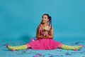 Lovely girl with a multi-colored braids hairstyle and bright make-up, posing in studio with lollipop, air balloons and Royalty Free Stock Photo