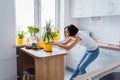 Lovely girl replanting flowers at home  relaxing after working day. Pouring the ground and fertilizer from the packaging  mixing Royalty Free Stock Photo