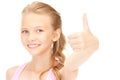 Lovely girl showing thumbs up sign Royalty Free Stock Photo