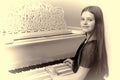 Lovely girl sitting at piano Royalty Free Stock Photo
