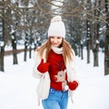 Lovely girl with a stylish retro sweater, a white winter jacket Royalty Free Stock Photo