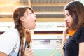 Lovely girl is using hand close her nose because her friend persecute and blow her bad breath to her. She eat some stink food. Pr Royalty Free Stock Photo