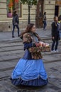 Lovely girl wearing historic outfit and sells candy in the Central Market Square in Lviv, Ukraine Royalty Free Stock Photo