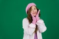 Lovely girl wearing pink french hat. young girl woman with a pink beret on her head France fashion on a green background