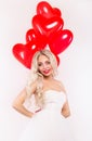 Lovely girl in a white dress with red balloons. Romantic concept. Royalty Free Stock Photo