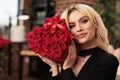 Lovely girlfriend posing with valentines day red roses bouquet Royalty Free Stock Photo