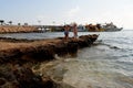 Lovely girls are exploring the rocky area at the beach bear the piers Royalty Free Stock Photo