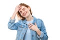 Lovely good-natured red-haired girl student in a blue denim jacket with a charming smile and a friendly expression, holding hands Royalty Free Stock Photo