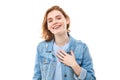 Lovely good-natured red-haired girl student in a blue denim jacket with a charming smile and a friendly expression, holding hands Royalty Free Stock Photo