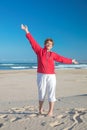 Lovely granny enjoys the freedom of a beach