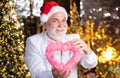 Lovely greetings. Senior man celebrate christmas. Kind grandpa with heart. Christmas decoration. Love and care. Charity