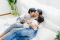 Lovely happy Asian family at cozy home. Son and daughter kiss mother with enjoy ,relax and playful together in bedroom. Happiness