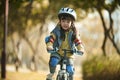 Little asian girl riding bike outdoors in city park Royalty Free Stock Photo