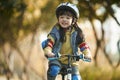 Little asian girl riding bike outdoors in city park Royalty Free Stock Photo