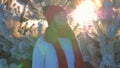 Woman In Sweater On Street In Winter Looking At Sunset And Mouth Exhales Vapor