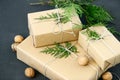 Lovely Holiday wrapping ideas rustic eco Christmas packages with brown paper, string and natural fir branches on dark background