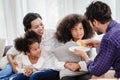Lovely home happy family living together in living room father mother playing with daughter mix race Royalty Free Stock Photo