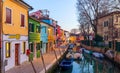 Lovely house facade and colorful walls in Burano, Venice. Burano island canal, colorful houses and boats, Venice landmark, Italy. Royalty Free Stock Photo