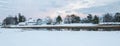 Lovely houses by the river on a winter evening. Panorama