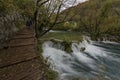 Lovely landscape with beautiful waterfall, wooden steps and autumn forest