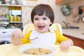 Lovely little boy eating soup with meat balls Royalty Free Stock Photo