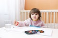 Lovely little boy painting with water color paints at home Royalty Free Stock Photo