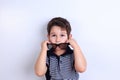 Lovely little boy putting off sunglasses, studio shoot on white. Royalty Free Stock Photo