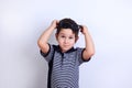 Lovely little boy putting off sunglasses, studio shoot on white. Royalty Free Stock Photo