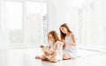 Lovely little girl brushing hair of younger sister Royalty Free Stock Photo