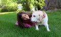 Lovely little girl with her best dog friend at park during summer in Michigan Royalty Free Stock Photo