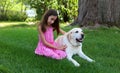 Lovely little girl with her best dog friend at park during summer in Michigan Royalty Free Stock Photo