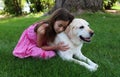 Lovely little girl with her best dog friend at park during summer in Michigan Royalty Free Stock Photo