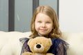 Lovely little girl hugging her teddy bear toy Royalty Free Stock Photo