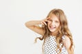 Lovely little girl in a polka-dot dress against a white background Royalty Free Stock Photo