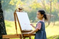 Lovely little girl show happy smile and enjoy with painting in the garden with morning light Royalty Free Stock Photo