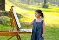 Lovely little girl show happy smile and enjoy with painting in the garden with morning light Royalty Free Stock Photo