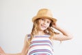 Lovely little girl with straw hat against a white background. Ha Royalty Free Stock Photo