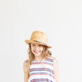 Lovely little girl with straw hat against a white background Royalty Free Stock Photo