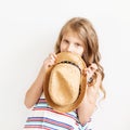 Lovely little girl with straw hat against a white background. Royalty Free Stock Photo