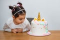 Lovely little girl waiting for eating birthday cake.